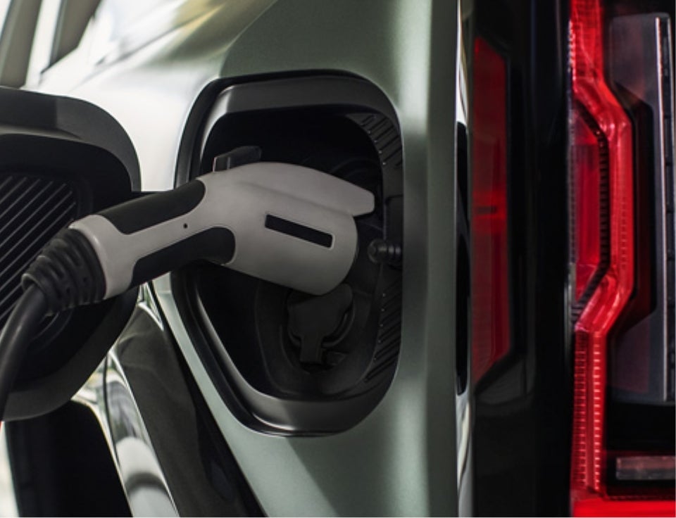Close up of charging port with charger plugged in on a GMC Hummer EV SUV - Wharton GMC in Wharton TX